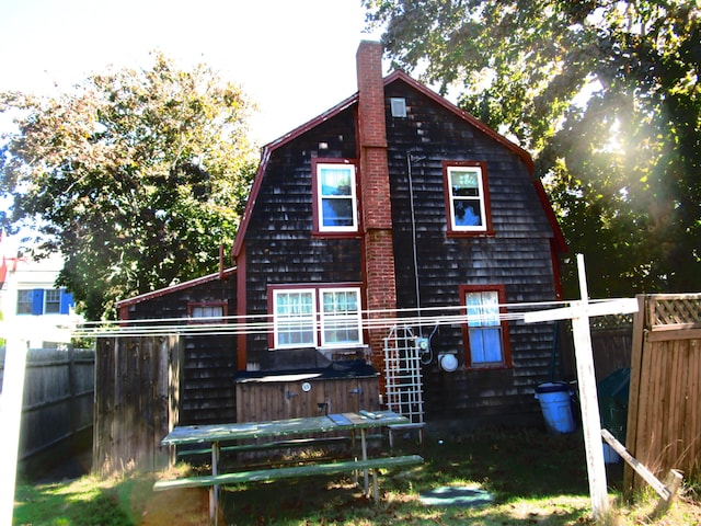 rear view of house with a jacuzzi