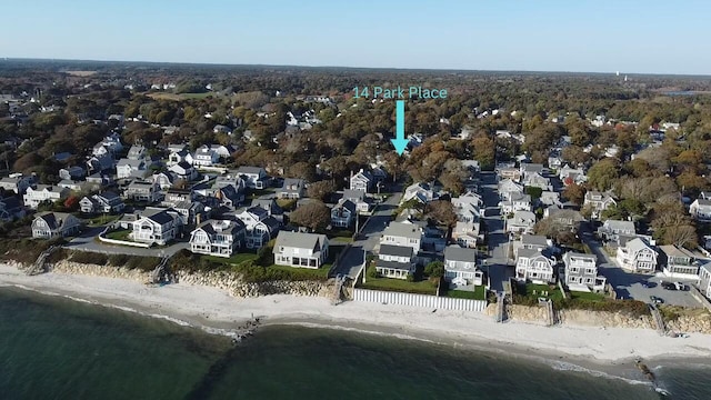 drone / aerial view featuring a water view and a view of the beach