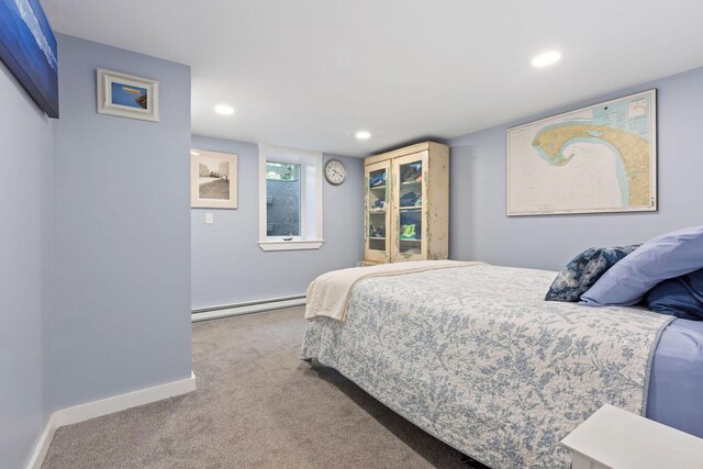 bedroom featuring carpet and a baseboard heating unit