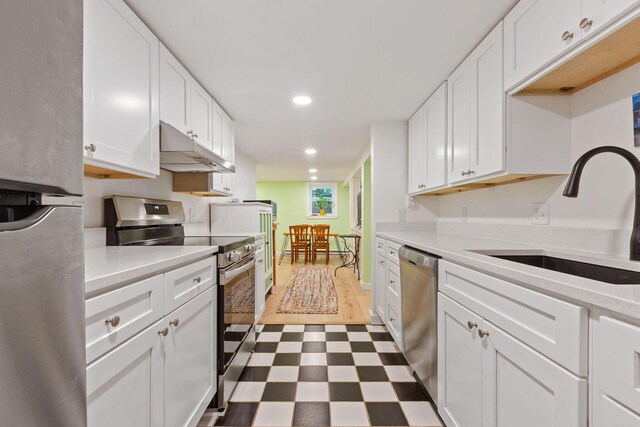 kitchen featuring sink, stainless steel appliances, and white cabinets