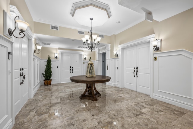 595 Main St Unit 37, Chatham, MA 02633 - foyer entrance with a decorative wall, a chandelier, wainscoting, and crown molding