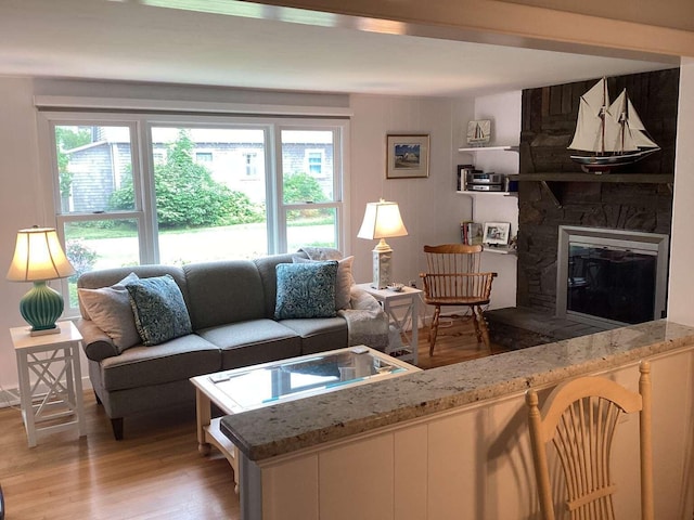 8 Saco Ave, Pocasset, MA 02559 - living room with light wood finished floors, plenty of natural light, and a fireplace