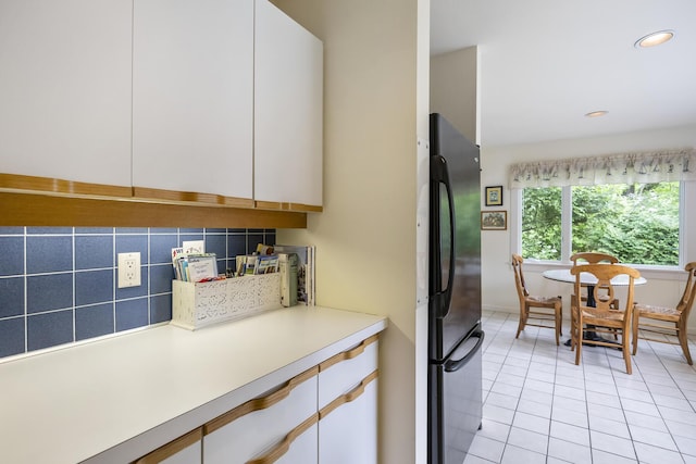 18 Juniper Cir, Brewster, MA 02631 - kitchen with freestanding refrigerator, light tile patterned floors, white cabinetry, light countertops, and recessed lighting