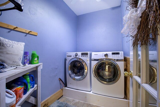 washroom with separate washer and dryer and light tile patterned floors