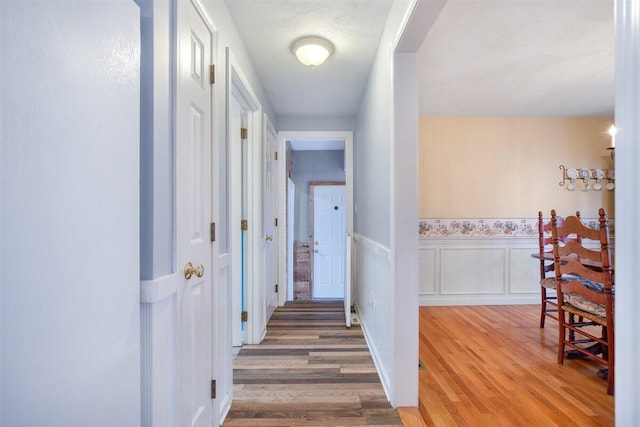 corridor with hardwood / wood-style floors