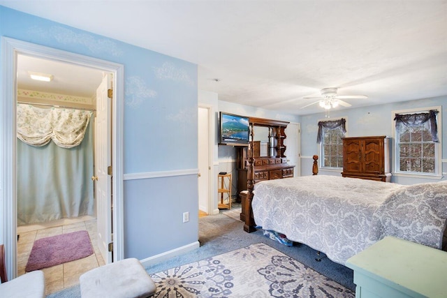 tiled bedroom featuring ceiling fan