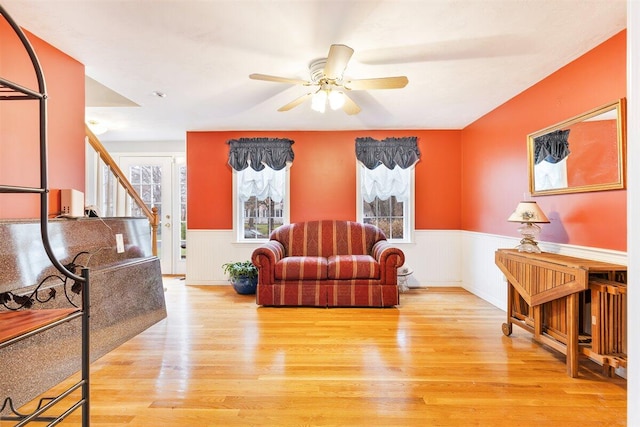 living area featuring light wood-type flooring and ceiling fan