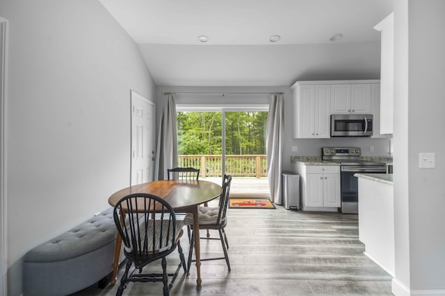 5 Whiffletree Cir, Sandwich, MA 02563 - dining area with light wood-style floors and vaulted ceiling