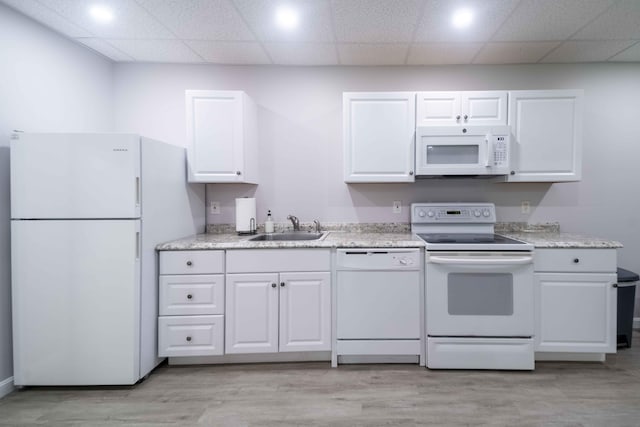 5 Whiffletree Cir, Sandwich, MA 02563 - kitchen with white appliances, a sink, white cabinets, light wood finished floors, and a paneled ceiling