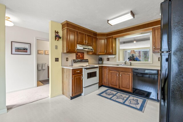 146 Crescent Ln, Brewster, MA 02631 - kitchen with black appliances, under cabinet range hood, a sink, light countertops, and brown cabinetry