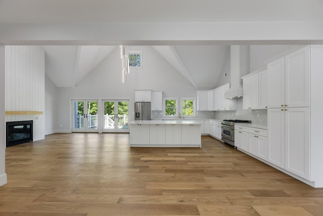 84 Hooppole Rd, Mashpee, MA 02649 - kitchen with appliances with stainless steel finishes, high vaulted ceiling, light countertops, white cabinets, and open floor plan