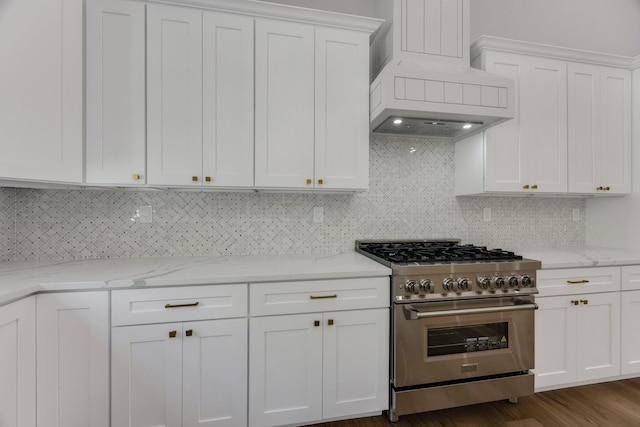 84 Hooppole Rd, Mashpee, MA 02649 - kitchen featuring stainless steel stove, custom range hood, white cabinetry, tasteful backsplash, and light stone counters