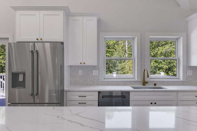 84 Hooppole Rd, Mashpee, MA 02649 - kitchen with stainless steel refrigerator with ice dispenser, a sink, dishwasher, backsplash, and light stone countertops