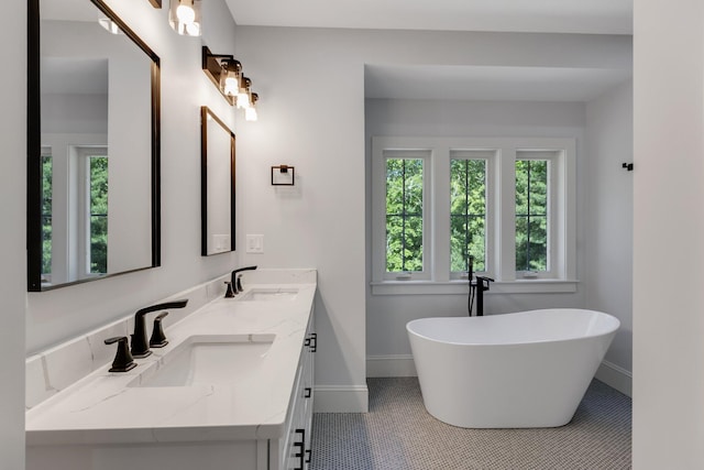 84 Hooppole Rd, Mashpee, MA 02649 - full bath featuring baseboards, double vanity, a freestanding bath, and tile patterned flooring