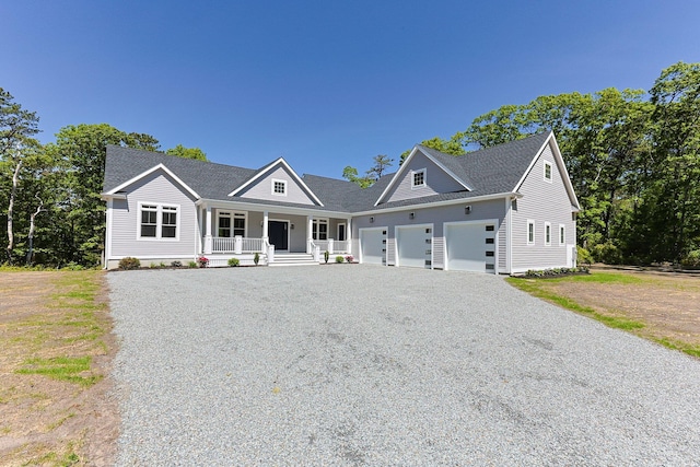 84 Hooppole Rd, Mashpee, MA 02649 - view of front of home with covered porch, gravel driveway, a garage, and a shingled roof