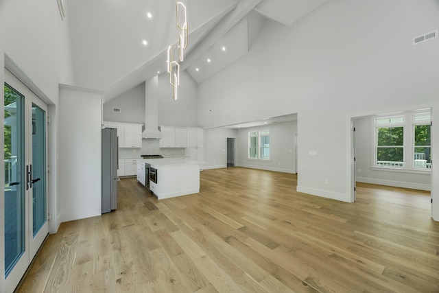 84 Hooppole Rd, Mashpee, MA 02649 - unfurnished living room featuring high vaulted ceiling, light wood-type flooring, plenty of natural light, recessed lighting, and beamed ceiling