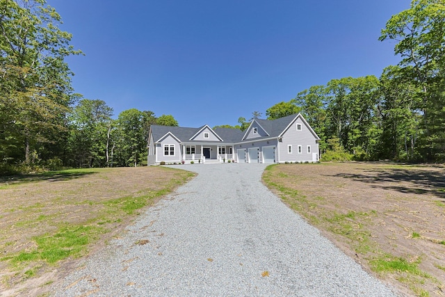 84 Hooppole Rd, Mashpee, MA 02649 - view of front of property with driveway, a porch, and a garage