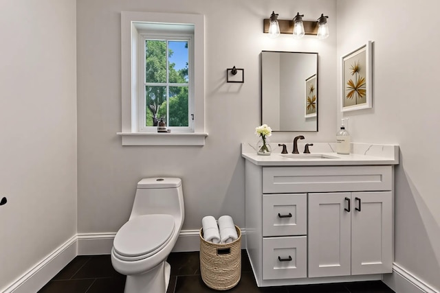 84 Hooppole Rd, Mashpee, MA 02649 - bathroom featuring baseboards, vanity, toilet, and tile patterned floors