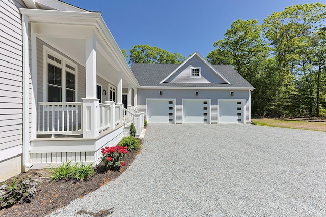 84 Hooppole Rd, Mashpee, MA 02649 - view of home's exterior with a porch, driveway, and a garage