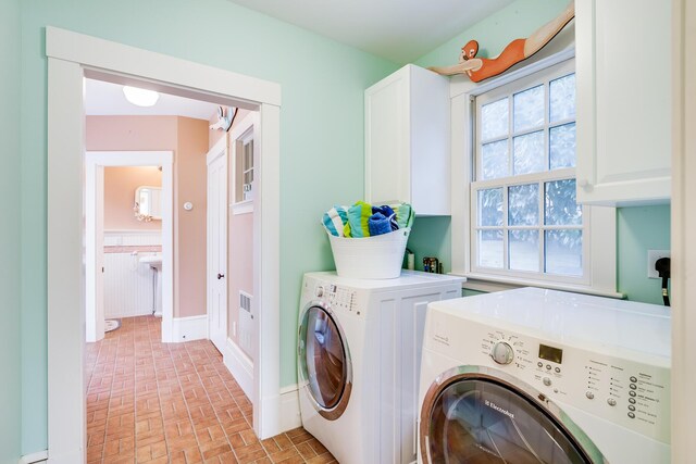 washroom with cabinets and separate washer and dryer