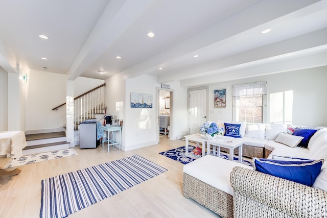 living room with beamed ceiling and light hardwood / wood-style flooring