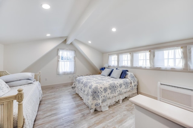 bedroom featuring multiple windows, light hardwood / wood-style flooring, and vaulted ceiling with beams