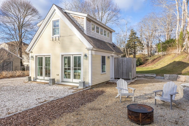 back of property featuring an outdoor fire pit