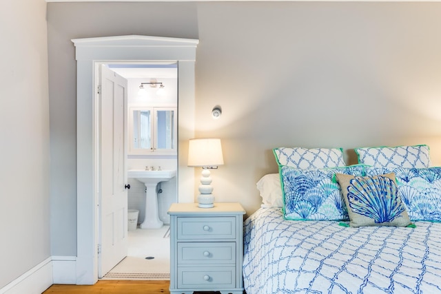 bedroom with sink and light wood-type flooring