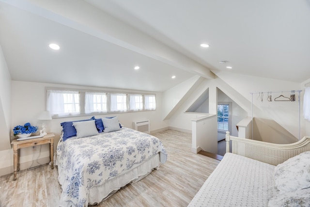 bedroom featuring vaulted ceiling with beams and light hardwood / wood-style flooring