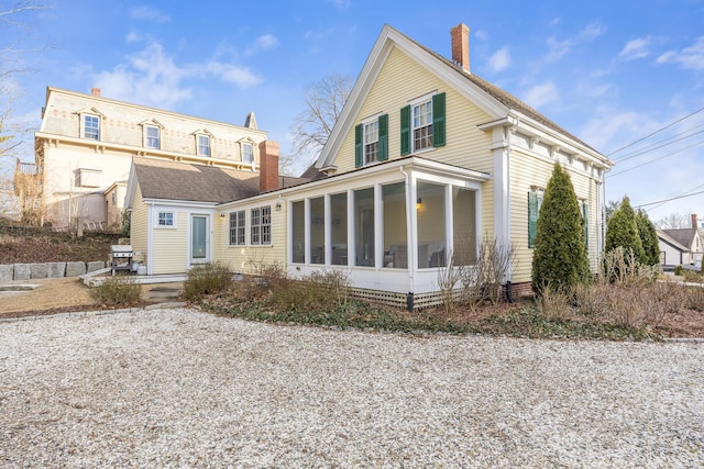 10 Bank St, Wellfleet, MA 02667 - back of property with a sunroom and a chimney