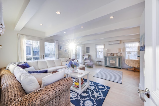 living room with beamed ceiling, light hardwood / wood-style flooring, french doors, and an AC wall unit