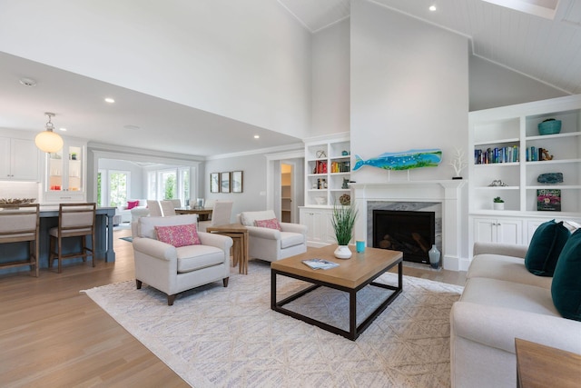 9 Joy Ln, Orleans, MA 02653 - living area featuring light wood-style flooring, high vaulted ceiling, a high end fireplace, built in shelves, and recessed lighting