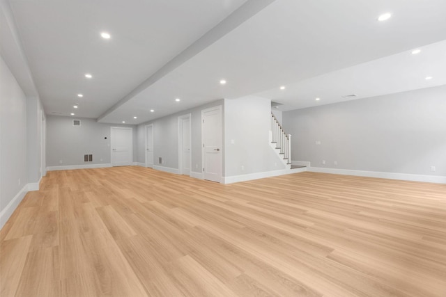 9 Joy Ln, Orleans, MA 02653 - unfurnished living room with stairs, baseboards, light wood-type flooring, and recessed lighting