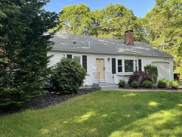 ranch-style home with a garage and a front yard