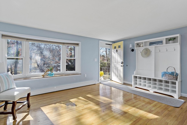 living area with a baseboard radiator and light wood-type flooring