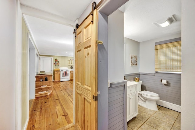 274 Morton Rd, South Chatham, MA 02659 - bathroom with baseboard heating, vanity, toilet, wainscoting, and wood-type flooring