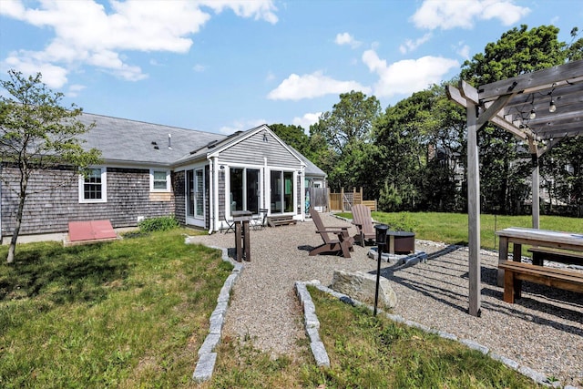 274 Morton Rd, South Chatham, MA 02659 - rear view of house featuring a pergola, a yard, a patio area, and an outdoor fire pit