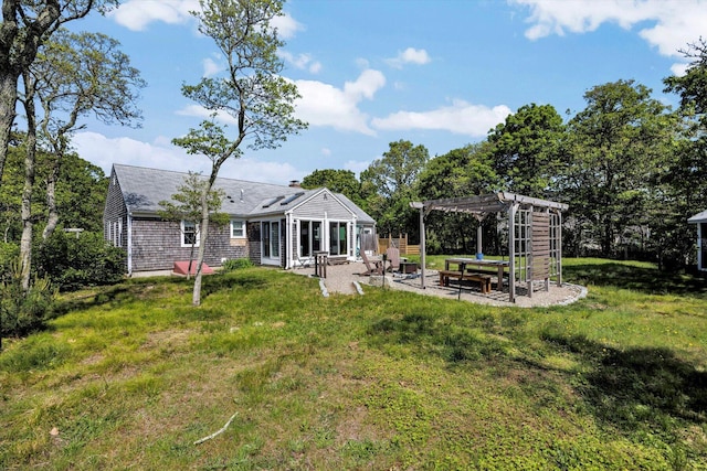 274 Morton Rd, South Chatham, MA 02659 - back of property featuring a pergola, a patio, a yard, and a chimney