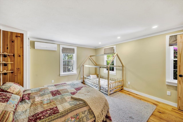 274 Morton Rd, South Chatham, MA 02659 - bedroom with a wall mounted air conditioner, wood finished floors, baseboards, and recessed lighting
