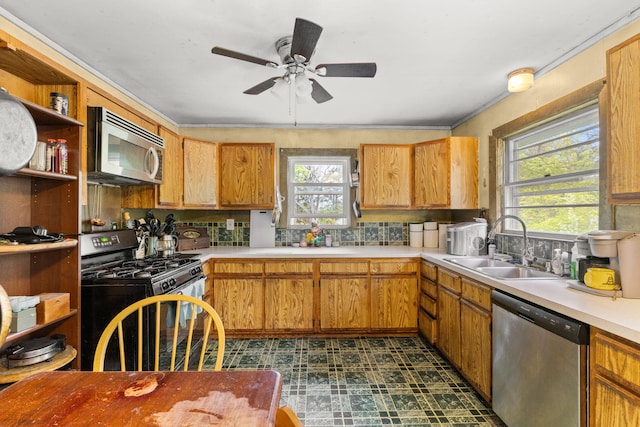 kitchen with appliances with stainless steel finishes, plenty of natural light, open shelves, and a sink