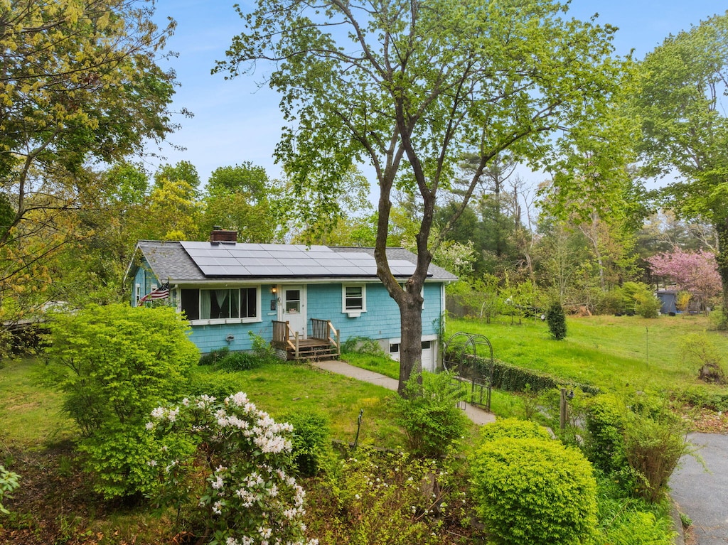 30 Trowbridge Rd, Bourne, MA 02532 - view of front facade with roof mounted solar panels and a chimney