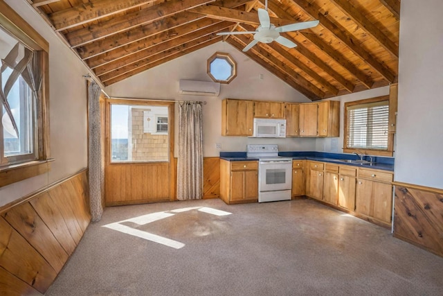 kitchen with white appliances, beamed ceiling, wooden walls, sink, and a wall mounted AC