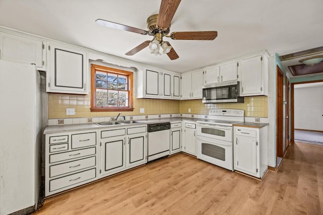 261 Old Chatham Rd, South Dennis, MA 02660 - kitchen with white appliances, backsplash, a sink, and light wood-style flooring
