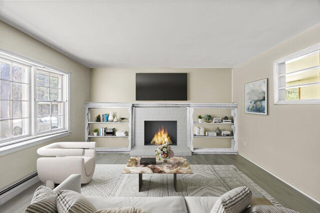 261 Old Chatham Rd, South Dennis, MA 02660 - living room featuring a baseboard radiator, wood finished floors, a brick fireplace, and baseboards