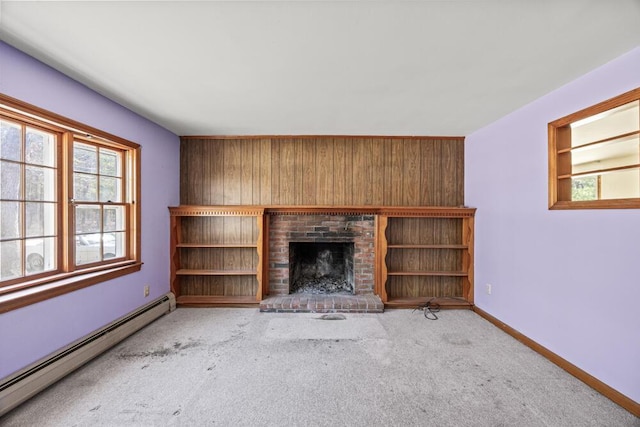 261 Old Chatham Rd, South Dennis, MA 02660 - unfurnished living room with baseboard heating, carpet floors, wood walls, a fireplace, and baseboards
