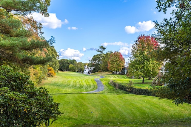 181 Leisure Green Dr, Mashpee, MA 02649 - surrounding community with golf course view, a yard, and view of wooded area