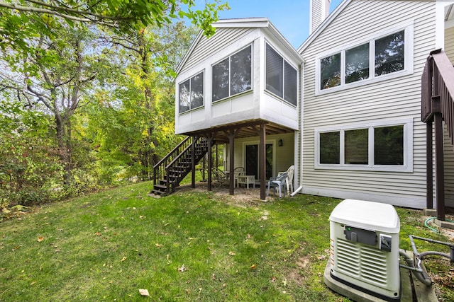 181 Leisure Green Dr, Mashpee, MA 02649 - back of house featuring a sunroom, stairway, a chimney, and a yard