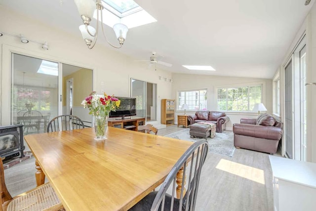 79 Rolling Hitch Rd, Centerville, MA 02632 - dining room featuring a skylight, lofted ceiling, a wood stove, wood finished floors, and ceiling fan