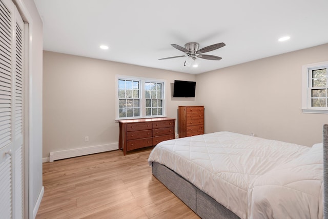 bedroom with light wood finished floors, recessed lighting, baseboards, and baseboard heating