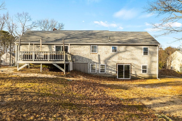 rear view of property featuring a deck